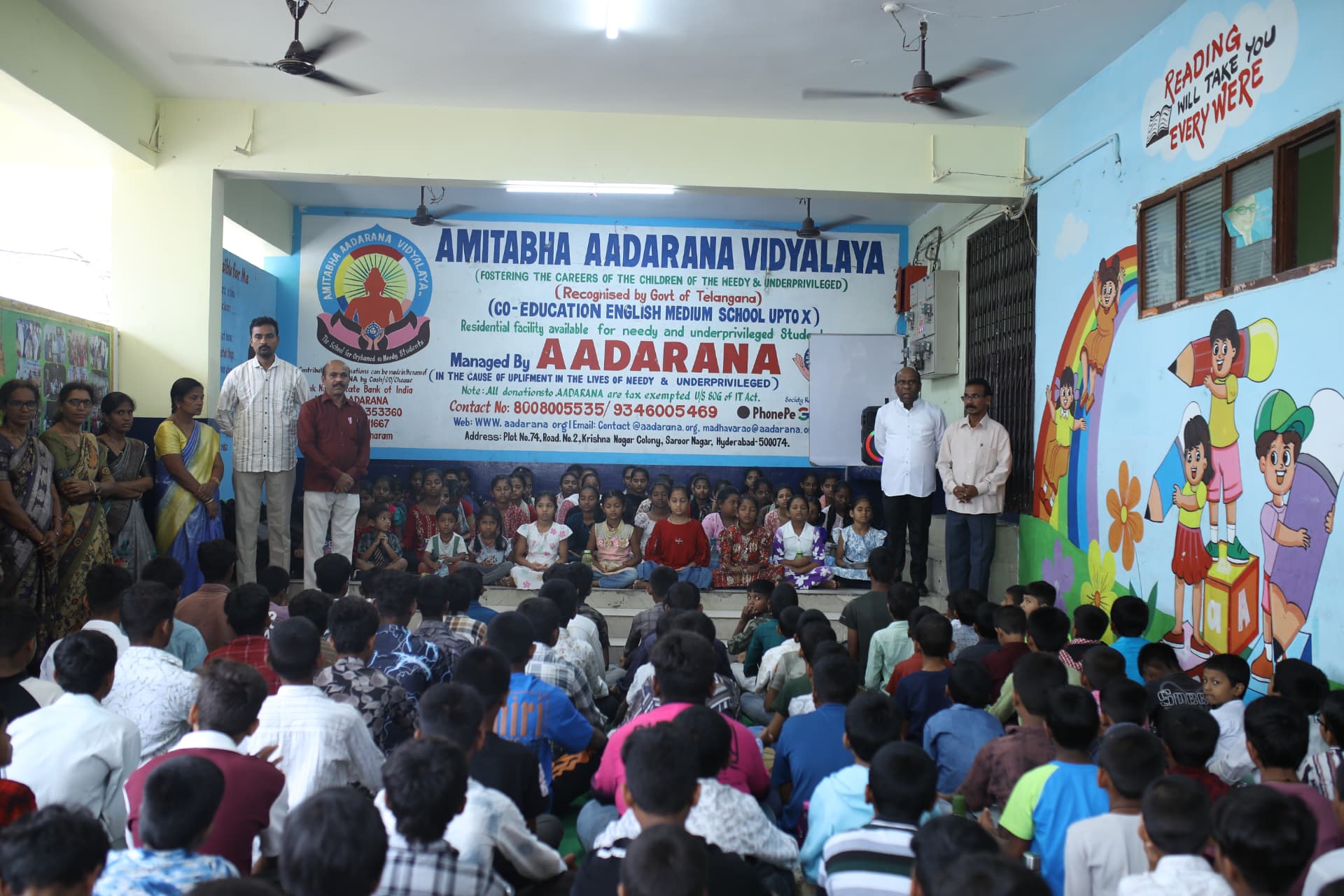 Children and staff gathered in the Amitabha Aadarana Vidyalaya hall