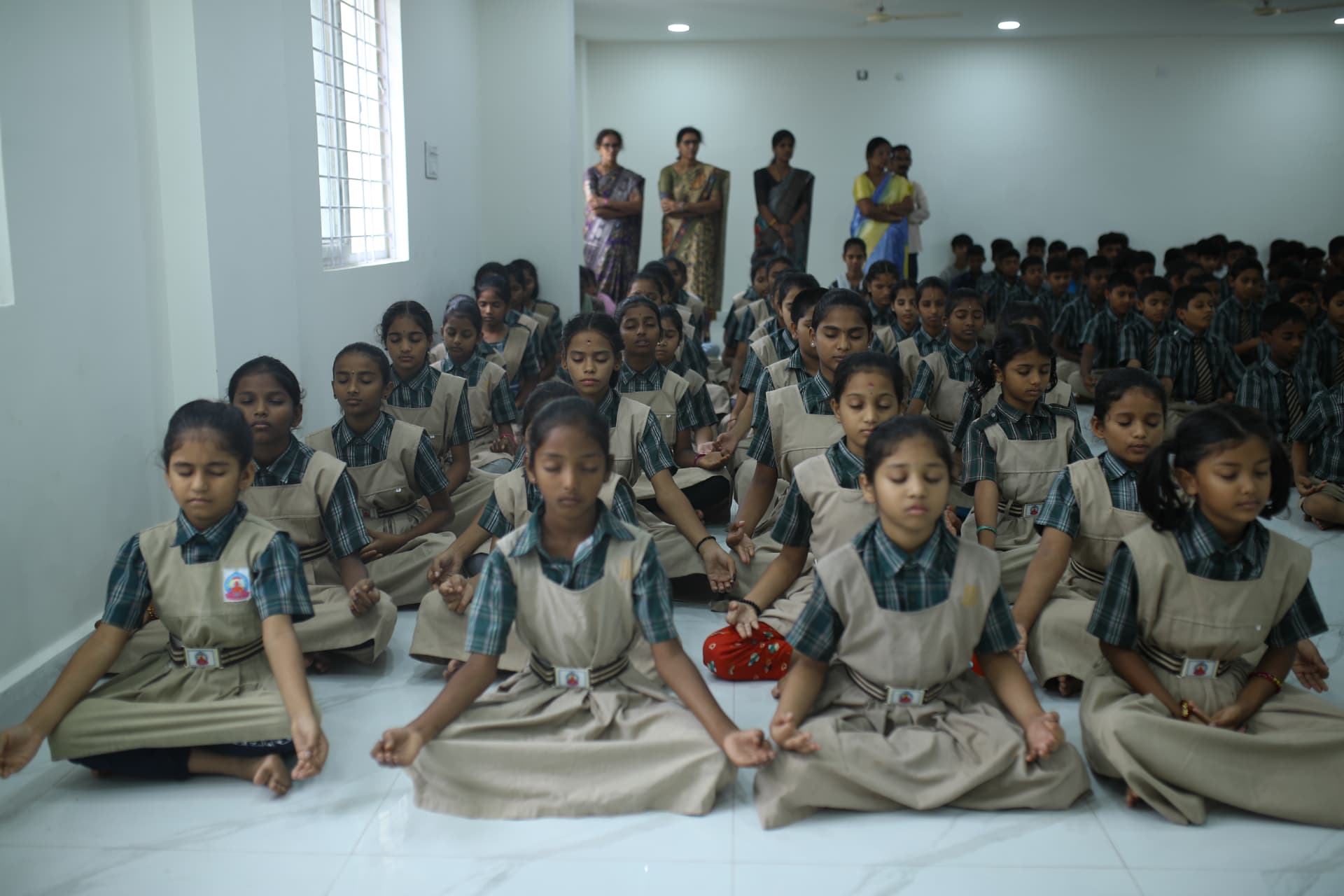 Aadarana students meditating together in the school hall