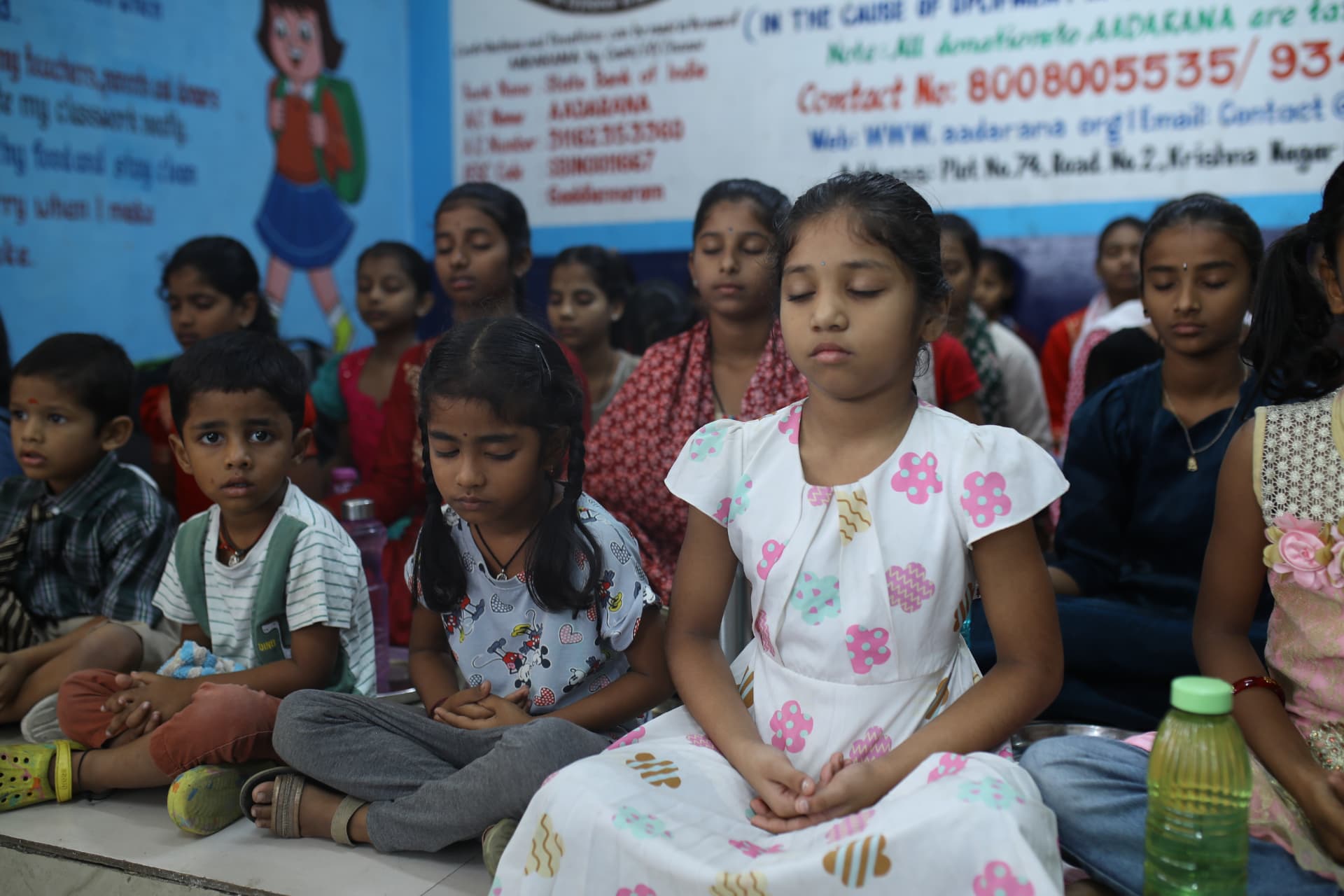 Children of different ages meditating together at Aadarana