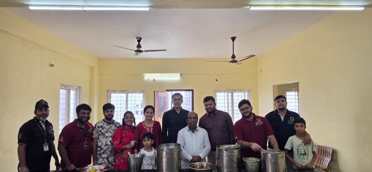 A sponsoring family and volunteers with the day's food, before serving