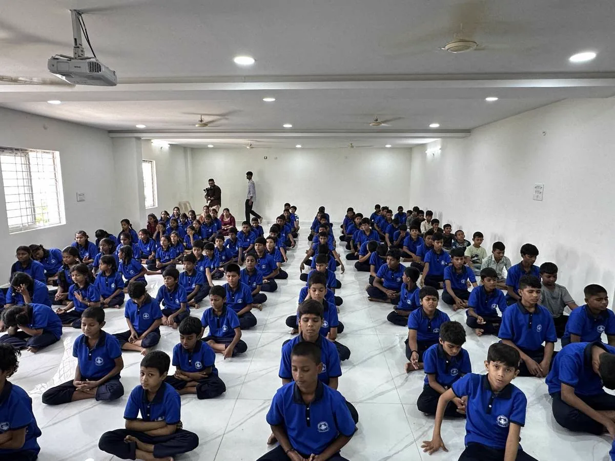 Children meditating in the assembly hall